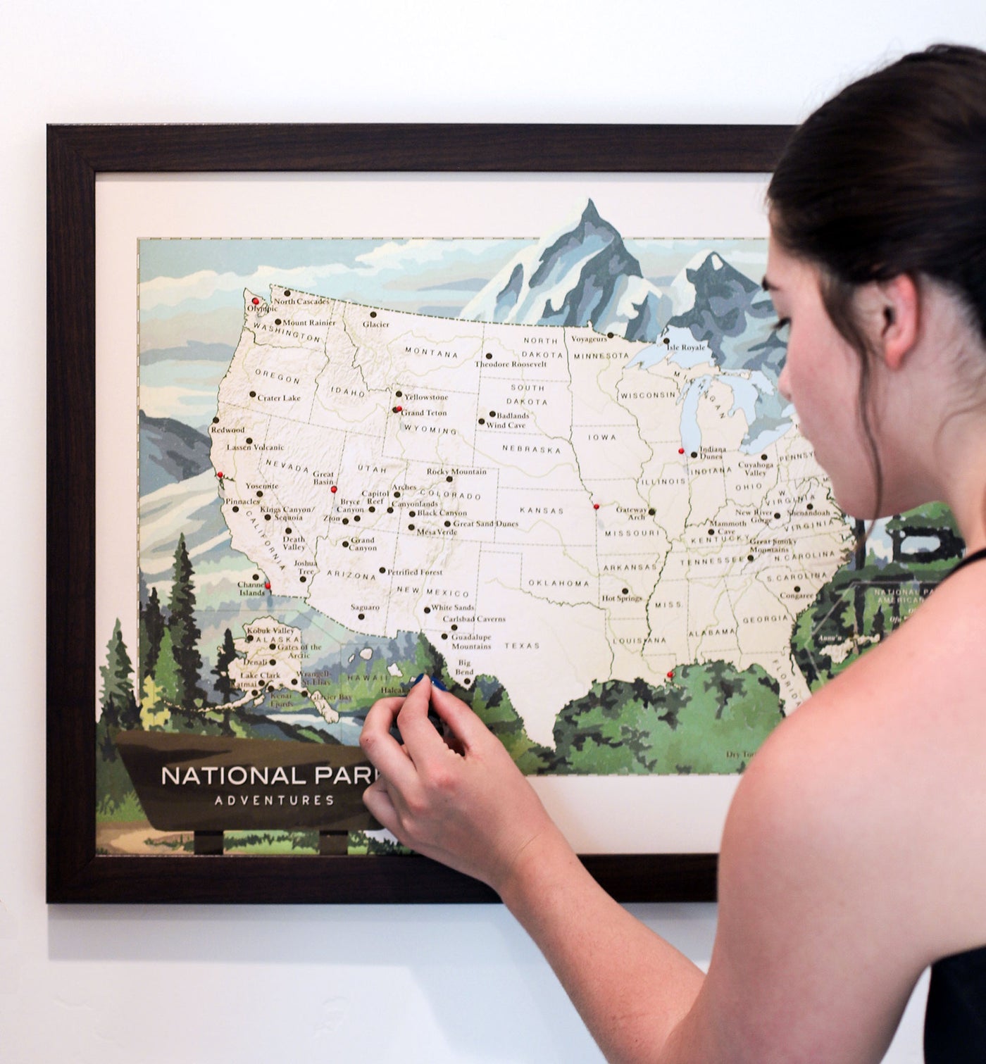 Girl pinning national parks map